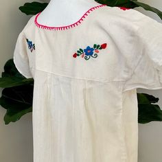 The Yucatan embroidered top is beautifully made in Merida Yucatan, Mexico, each piece is fully hand embroidery. Details: Size S/M measurements: Bust: 40” - 27” length(shoulder to bottom Hem) Cotton thread Embroidered Material: 100% Cotton split sides All items are shipped from the US All Mi Mundo Mexicano items are 100% handmade by artisans in Mexico. Each stitch and item is completely unique and one-of-a-kind, so you'll never find two that are exactly the same! All items may vary slightly in si Traditional Cotton Tops With Tonal Embroidery, Fitted Folk Top With Embroidered Border, Folk Style Cotton Top With Tonal Embroidery, Traditional Cotton Blouse With Tonal Embroidery, Traditional Fitted Tops With Embroidered Border, Fitted Traditional Tops With Embroidered Border, Fitted Cotton Embroidered Top With Neckline Detail, Traditional Fitted Embroidered Top With Embroidered Border, Fitted Traditional Embroidered Top With Embroidered Border