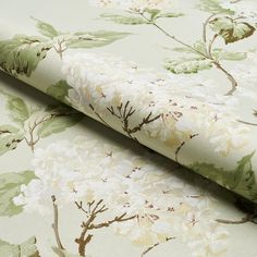 a close up view of a wallpaper with white and green flowers