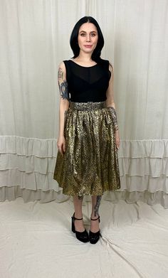 "Super fun and easy to wear, this vintage 80's dress by Jolie is begging for a night out on the town! The bodice is a textured black poly and the skirt features a sporty dirty gold lame design PLUS a layer of tulle for some flounce. It does include a matching belt! It's in great vintage condition - the belt has seen better days...but it definitely still does the job. It's a pullover style, so easy breezy...but still makes a statement! Note that the bodice is a tiny bit sheer. I believe this piece would best fit a modern size XS to S. The waist is stretchy and the belt does allow for a bit of cinching, if needed. Check the measurements below and compare to your own before purchasing,please. Measurements (taken flat): Tag: M Bust: 16\" Waist: 13-15\" Hips: Full Length: 30\" Model Measurement Bride Of Chucky Halloween, Lamé Dress, 80’s Dresses, Lame Dress, Bride Of Chucky, Vintage Dress 80s, Flair Dress, Gold Lame, Better Days