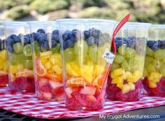 plastic cups filled with different types of fruit