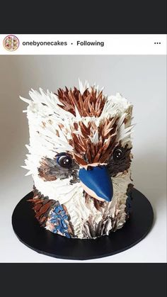 a cake made to look like an eagle with feathers on it's head and eyes