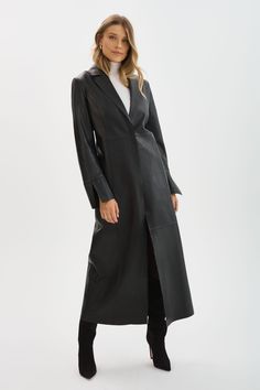 Step out in style with the Evanna Leather Maxi Coat. This single-breasted coat features lateral side slits, clean lines and minimalist details. Whether you're heading to a formal event or simply want to elevate your everyday look, the Evanna Leather Maxi Coat is the perfect choice. Modern Evening Outerwear With Hidden Button Closure, Modern Outerwear With Hidden Button Closure For Evening, Chic Evening Outerwear With Pressed Crease, Modern Evening Outerwear With Lapel Collar, Single-breasted Long Leather Jacket For Work, Elegant Single-breasted Long Leather Jacket, Single-breasted Leather Long Coat For Work, Elegant Single Breasted Long Leather Jacket, Single Breasted Leather Long Coat For Work