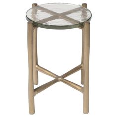 a small table with a glass top and gold legs