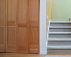 an empty room with stairs leading up to the closet