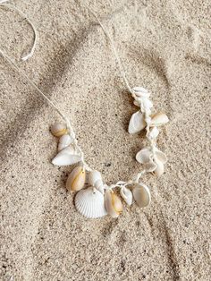 Embrace the essence of the ocean with our Boho Seashell Choker Necklace—an exquisite accessory for beach lovers and free spirits alike. Perfect for your next beach vacation, a seaside wedding, or simply adding a touch of coastal charm to your everyday look, this necklace captures the beauty of the sea in a minimalist, boho-inspired design. Handcrafted with natural seashells, each choker is a unique piece of ocean treasure that resonates with the tranquil vibes of the beach. Its simple yet elegan Cheap Beachy Shell Necklace As A Gift, Cheap Brown Shell Necklace For Gift, Cheap Handmade Casual Shell Necklace, Affordable Beachy Shell Necklace, Cheap Shell Beaded Necklaces For Beach, Cheap Bohemian Shell Necklace For Gifts, Small Seashell Necklace, Cheap Handmade Shell Necklace, Luxury Bohemian Shell Necklaces