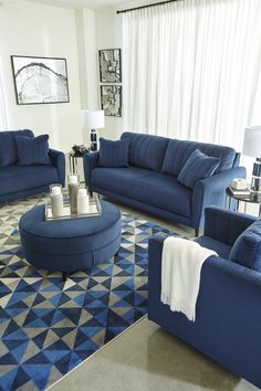 a living room filled with blue couches and chairs