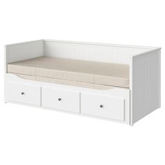 a white daybed with drawers underneath it and a pillow on the bottom shelf below