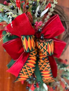 a christmas wreath with red and green bows