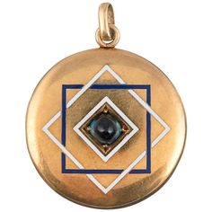 A perfectly round and mid-size 18k yellow gold locket displaying the complex beauty that is characteristic of late Victorian jewelry. The piece is decorated on the front with a sugar-loaf cabochon sapphire, set in the center of blue and white geometric enamel designs and is presented in beautifully preserved condition. Luxury Classic Cabochons As Gifts, Enamel Locket, Carmel By The Sea, Gold Locket, Mid Size, Victorian Jewelry, Estate Jewelry, Vintage Watches, Locket