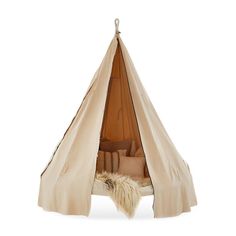 a teepee tent with pillows and blankets in it on a white background for use as a bed