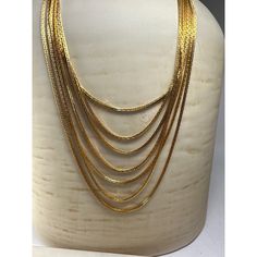 "A Vintage Trifari Signed Seven-Strand Necklace from the 1960s is a stunning piece of jewelry that exudes the charm and elegance of the era. This necklace is a true testament to Trifari's craftsmanship and design expertise, showcasing the brand's iconic style and attention to detail. Shortest strand clasp to clasp 21\" Condition: New Without Tags Excellent Condition. Never Worn." Gold-tone Multi-strand Necklaces For Formal Occasions, Gold-tone Multi-strand Necklace For Formal Occasions, Elegant Gold-tone Collectible Jewelry, Gold Multi-strand Jewelry For Formal Occasions, Vintage Jewelry 16 Inch Length, Gold-tone Multi-strand Jewelry Gift, Gold-tone Multi-strand Jewelry For Gifts, Gold-tone Multi-strand Jewelry As A Gift, Formal Hallmarked Snake Chain Necklace