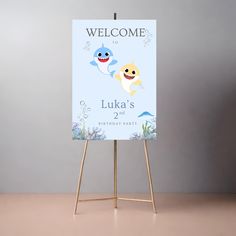 a welcome sign with two cartoon fish on it and the words luka's 2nd birthday party