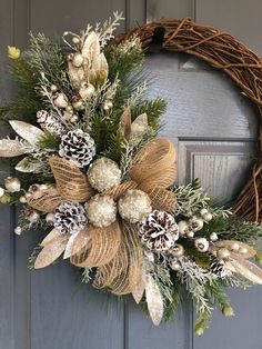 a wreath on the front door with pine cones and other decorations