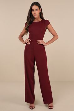 The Lulus Illustrious Charm Burgundy Cap Sleeve Cutout Jumpsuit is the easiest way to reach icon status! Sleek, crepe woven fabric shapes this ultra chic jumpsuit that features a princess-seamed bodice, trendy cap-style sleeves (with gathering at the shoulders), and a crew neckline. The fitted waist sits atop figure-skimming, straight pant legs that fall to full-length hems. A trio of button-loop closures secure above a flirty open-back cutout for perfect finish. Hidden back zipper/clasp. Fit: T Cutout Jumpsuit, Trendy Caps, Chic Jumpsuit, Jumpsuit Chic, Adhesive Bra, Jumpsuit With Sleeves, Straight Pants, Cap Sleeve, Floor Length