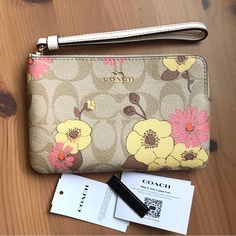 Price Firm Signature Coated Canvas And Smooth Leather Two Credit Card Slots Zip-Top Closure, Fabric Lining Wrist Strap Attached 6 1/4" (L) X 4" (H) X 1/2" (W) Style No. Ci856 Placement Of Flower Prints May Vary Chic Beige Bags With Wrist Strap, Coach Beige Pouch Wristlet, Coach Beige Bag With Zipper Pouch, Beige Coach Pouch Wristlet, Coach Beige Wristlet With Removable Pouch, Beige Rectangular Wristlet For Spring, Chic Beige Pouch Wristlet, Cream Clutch For Daily Use, Rectangular Beige Wristlet For Spring