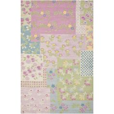 a multicolored area rug with flowers and squares on the front, in pastel colors