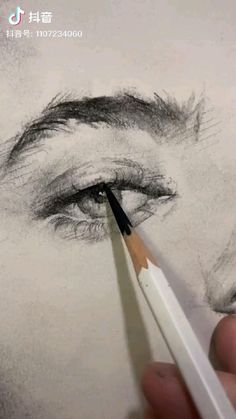 someone is drawing a woman's eye with pencils