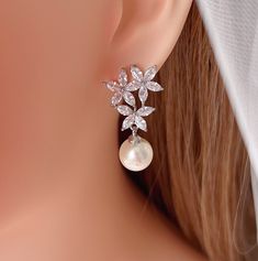 a close up of a pair of earrings on a mannequin's head