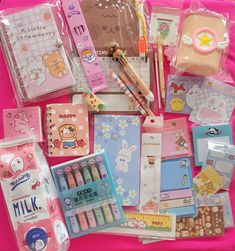 various stationery items laid out on a pink blanket