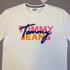 Brand New With Tags!!! No Scratches/Stains/Tears. Material: 100% Cotton. Size Of T-Shirt In Pictures. Tommy Hilfiger Sporty T-shirt With Graphic Print, Tommy Hilfiger Sporty Graphic Print T-shirt, Tommy Hilfiger Graphic Tee For Summer, Tommy Hilfiger Summer Graphic Tee, Tommy Hilfiger Graphic Print T-shirt For Summer, Tommy Hilfiger White T-shirt With Graphic Print, Tommy Hilfiger Graphic Tee With Graphic Print, Tommy Hilfiger Graphic Print Tee, Trendy Tommy Hilfiger Cotton T-shirt