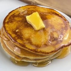 a stack of pancakes with butter on top and syrup drizzled over them