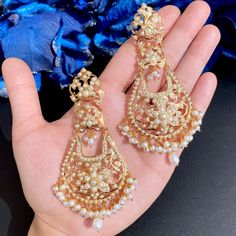 Featured is a jadau necklace set studded with freshwater pearls.The necklace is supplied with a fancy tassel/dori and the earrings close with a bombay screw. You can upgrade the necklace to an adjustable length gold plated backchain for an additional Rs 1000. Elegant Kundan Chandelier Earrings With Pearl Drop, Elegant Pearl Drop Danglers For Reception, Elegant Chandbalis With Latkans For Celebration, Bollywood Pearl Drop Earrings For Reception, Kundan Bridal Earrings With Pearl Drop For Formal Occasions, Formal Kundan Bridal Earrings With Pearl Drop, Pearl Bridal Earrings With Meenakari For Celebration, Pearl Drop Earrings For Receptions And Festivals, Elegant Pearl Meenakari Earrings For Diwali