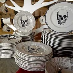 a table topped with lots of plates covered in skulls