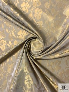 an image of a gold and silver floral pattern on a plain fabric with metallic foil