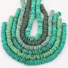 a group of turquoise and green beads