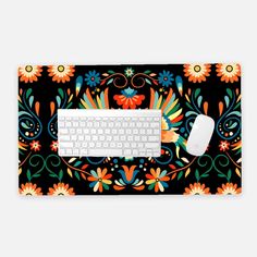 a computer keyboard and mouse sitting next to each other on a colorful floral design surface