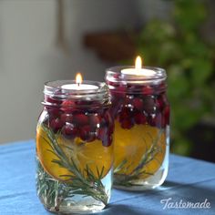 two mason jars filled with lemons and cranberries