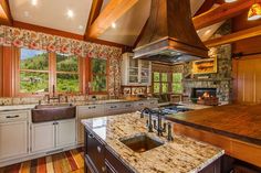 a kitchen with granite counter tops and wooden cabinets, along with an island in the middle