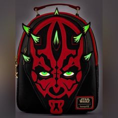 a darth vader bag with green eyes and spikes on the front is shown