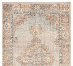 an antique rug with blue and orange accents on the front, in neutral tones to the back