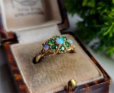 A TRULY LOVELY VINTAGE RING A Gorgeous Combination of Emerald and Opals in a Superb Solid 9ct Gold Setting The Ring comes with a set of Full British Hallmarks for authenticity Emeralds Measures 2.5mm Outer Opals measure 2.5mm each Middle Opal is 3mm Size UK O Size USA 7 RESIZING AVAILABLE Vintage Opal Ring Gift, Vintage Multi-stone Yellow Gold Opal Ring, Antique Multi-stone Opal Ring For Anniversary, Vintage Hallmarked Opal Ring For Anniversary, Vintage 14k Stamped Opal Ring Gift, Vintage Cluster Ring With May Birthstone For Anniversary, Vintage Collectible Hallmarked Opal Ring, Vintage Green Cluster Ring, Vintage Multi-stone Emerald Ring