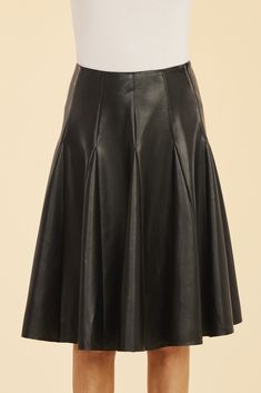 Our Faux Leather Paneled Skate Skirt, designed to blend sophistication and edge, is the perfect addition to your fall wardrobe. This knee-length, faux leather skirt features sleek panels and a flattering pleated silhouette that adds a playful yet structured look. The paneled design creates dynamic movement while offering a chic touch that pairs effortlessly with your favorite boots and sweaters. Faux leather Knee-length Paneled and pleated Available in Black and White Dry clean Style: 75484 Classic Leather Skirt For Fall, Leather Relaxed Fit Lined Skirt, Fitted Flared Leather Skirt, Relaxed Flared Leather Skirt, Relaxed Knee-length Leather Skirt, Chic Accordion Pleats Mini Skirt For Fall, Leather Lined Midi Skirt, Leather Midi Skirt With Lining, Fitted Leather Flared Skirt