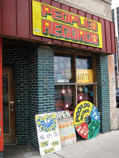 a store front with several signs on the side of it that say people records and don't speak to me