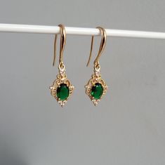 14k Gold Plated Hook Earrings with Emerald Gemstone Charms, Vintage Style Earrings, Filigree Charms, Emerald Hook Earrings Product specifications: * Material: 14K Gold Plated Brass * Size 3.7cm drop length. Each charm measures 2cm. Packaging and Gifts: * All pieces of jewellery are set on a card in a mesh jewellery pouch Shipping: * All orders will be shipped out within 1 - 3 days by standard untracked letter post. If you require tracking, please upgrade to that option at the time of checkout. F Emerald Jewelry Vintage, Vintage Style Earrings, Emerald Jewelry, Emerald Gemstone, Online Earrings, Style Earrings, Vintage Jewellery, Jewelry Pouch, Hook Earrings