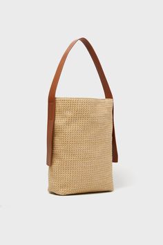 The best summer days are ones spent strolling the streets with the Huntington Raffia Bucket Bag. Perfectly slouchy with spacious interior, sleek elongated handles and a secure magnetic closure, making it perfect for everyday use. Whether you're heading to the market, the beach, or out for brunch with friends, its neutral color and classic silhouette pair effortlessly with anything from jeans to sundresses. Bucket silhouette Single shoulder strap Open top with magnetic closure Bottom feet Interio Raffia Bucket Bag, Sundress Season, 50th Clothing, The Best Summer, Sports Shops, Spring Trends, Classic Silhouette, Open Top, Neutral Color