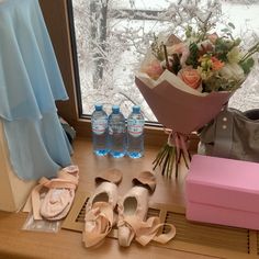 flowers, shoes and water bottles on a window sill