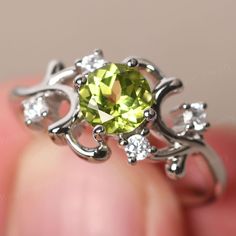 This is a gorgeous handmade creation. Its beauty is its simplicity & Elegance. The (6*6mm round cut natural peridot) is crafted in solid sterling silver / 14k gold. It is available to customized, if you have any mind, just let me know, we will discuss with it. All item is sent in a beautiful gift box You can realize more lovely stuff clicking the link https://www.etsy.com/shop/knightjewelry?refshopsection_shophome_leftnav Please leave the correct address and you PHONE NUMBER for delivering succe Wedding Ring Round, August Birthstone Ring, September Birthstone Rings, Green Amethyst Ring, Wedding Rings Round, Emerald Cut Engagement, Sapphire Wedding, August Birthstone, Engagement Ring Cuts