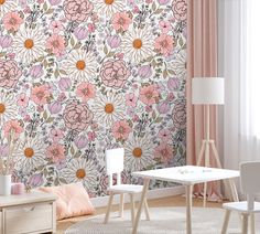 a living room with pink flowers on the wall and white chairs in front of it