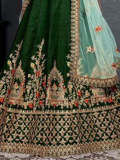 Look gorgeous in this stunning bottle green embroidered silk bridal lehenga choli from Ethnic Plus. This exquisite lehenga set is perfect for women who want to make a statement at their upcoming weddings and special occasions.
The lehenga is made of high-quality taffeta silk material in a beautiful bottle green color. It features intricate zari work, dori work, sequin work, diamond work, and embroidery work, adding a touch of elegance and sophistication. The attention to detail on this lehenga i Silk Bridal Lehenga, Dori Work, Zari Embroidery, Bridal Lehenga Choli, Bottle Green, Stone Work, Silk Material, Satin Silk, Bridal Lehenga