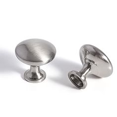 two metal knobs are shown on a white background