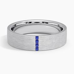 a men's wedding band with blue sapphire stones