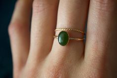 STUNNING 14k gold filled or Sterling Silver handmade Nephrite Jade ring set ✨ * Listing covers both the  Nephrite Jade ring and twisted band.  Beautiful 8x6mm natural oval olive green Jade gemstone✨⚒️  Jade is a special stone that is believed to promote wisdom, balance, and peace. Jade has a history that traces back to prehistoric times, to the ancient Chinese, the Maori, and to the Aztecs and Inca peoples of Central America.  Reputed by folklore to attract love, this stone was also believed to deliver prosperity and power to those who wore or carried it. * Please note photos are zoomed in up close, therefore the size of the stone may appear slightly larger in photos. Model is wearing a size US 5.5. Please refer to stone measurement to best determine the size & look you're looking for.  Ma Jade Stone Engagement Ring, Vintage Jade Ring, Jade Gold Ring, Dainty Green 14k Gold Stackable Rings, Dainty Green Round Midi Rings, Gold Ring Green Stone, Jade Wedding Ring, Jade Rings For Women, Jade Engagement Ring