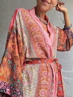 "This is one of a kind patchwork, upcycled silky robe Made free size with wrap tie closing and wide kimono sleeves  Easy and fun to wear around the house or outside as a urban boho style,  flowy kardigan with jeans and tshirt  It is very comfy and feels soft and light  the material is colourful indian saree silk made into this unique stylish over all MEAESURE free size length 55\" MATERIAL *polyester and silk * no lining more avaialable at  https://www.etsy.com/shop/AltheaStores? CARE INSTRUCTIO Multicolor Wrap Kimono For Festivals, Hippie Multicolor Open Front Kimono, Hippie Style Multicolor Wrap Kimono, Colorful Summer Kimono With Kimono Sleeves, Patchwork Kimono For Summer Festivals, Pink Wrap Kimono In Bohemian Style, Pink Hippie Kimono For Summer, Hippie Patchwork Kimono For Spring, Spring Festival Kimono With Patchwork