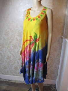 "Vintage tie dye summer dress in mainly yellow and blue. but has other bright colours.  It is sleeveless with a round neck and a very flared skirt.  This dress is lovely. Bust flat;  22\" Length;  39\" Made in India" Colorful Bohemian Summer Dress, Colorful Bohemian Maxi Dress For Summer, Hippie Multicolor Dresses For Beach Season, Multicolor Hippie Boho Dress For Beach Season, Yellow Boho Dress With Floral Print For Vacation, Yellow Casual Boho Beach Dress, Casual Yellow Boho Beach Dress, Vibrant Colorful Summer Dress, Yellow Sundress For Summer Beach Cover-up