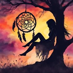 a woman sitting under a tree next to a dream catcher