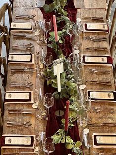 the table is set with wine glasses and place settings for guests to sit down at